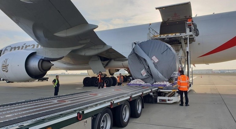 Powered cargo roller being used to safely load an areoplane engine